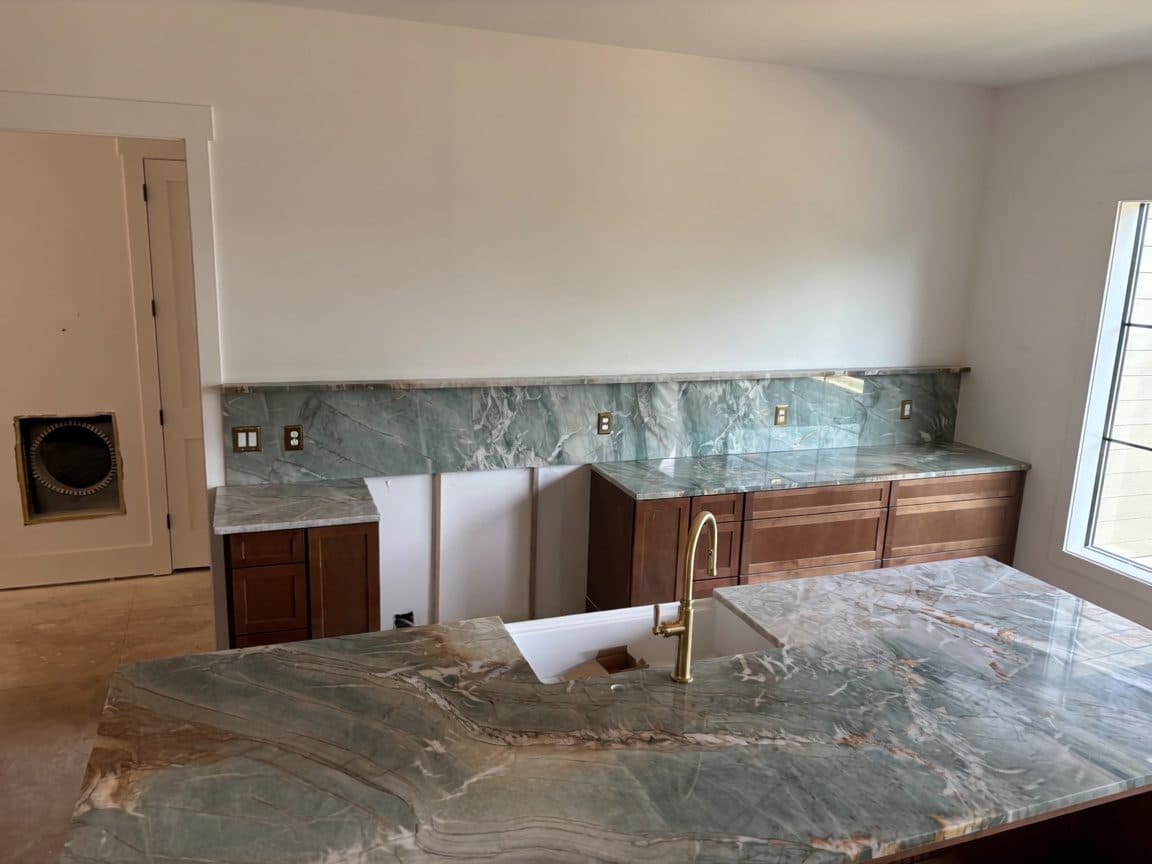 Green quartzite kitchen with full-height slab backsplash