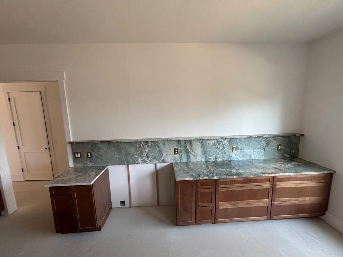 Green quartzite kitchen with full-height slab backsplash