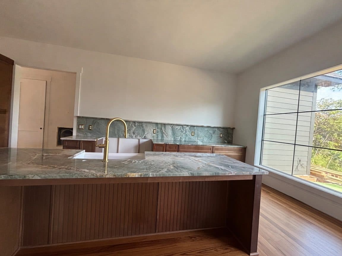 Green quartzite kitchen with full-height slab backsplash